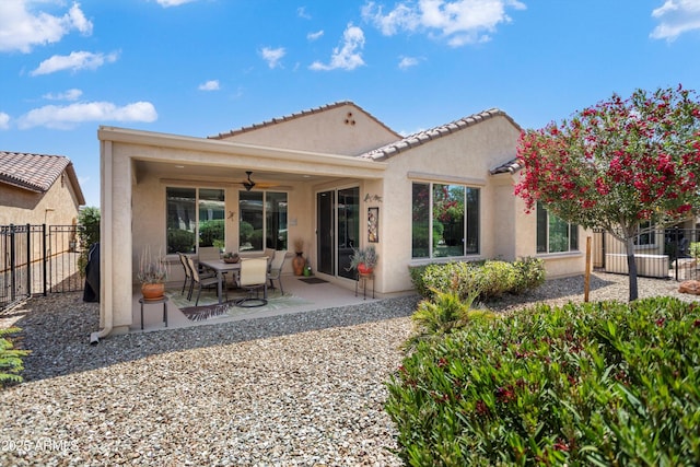 back of house featuring ceiling fan, fence, a patio area, and stucco siding