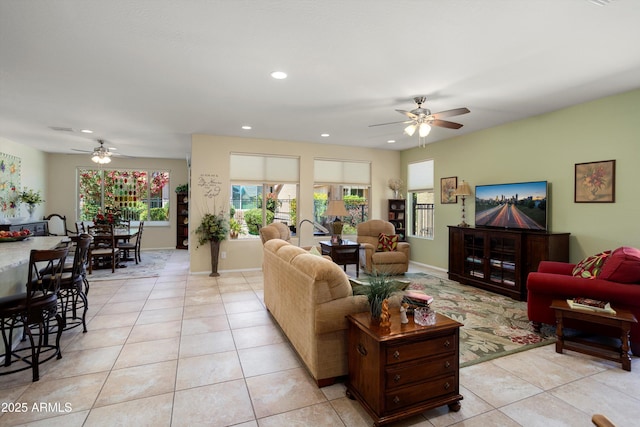 living area featuring recessed lighting, a ceiling fan, baseboards, and light tile patterned floors