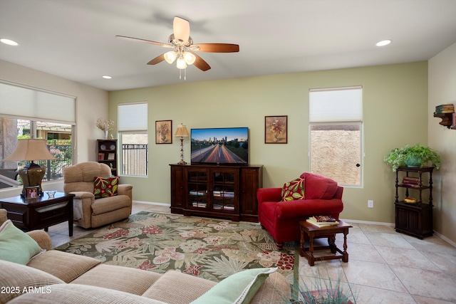 living area featuring light tile patterned floors, baseboards, a ceiling fan, and recessed lighting