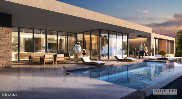 pool at dusk featuring a patio area and an outdoor pool