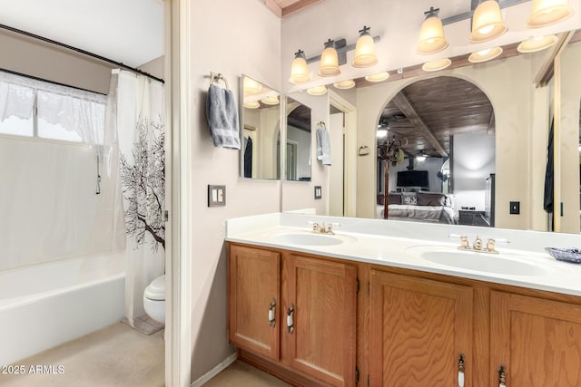 full bathroom with shower / bath combination with curtain, vanity, and toilet