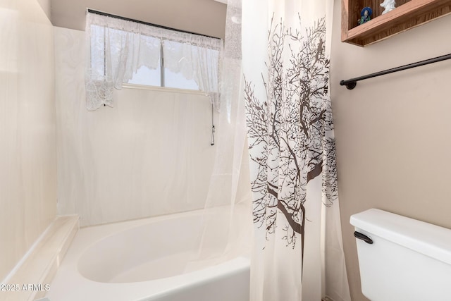 bathroom featuring shower / bath combo with shower curtain and toilet