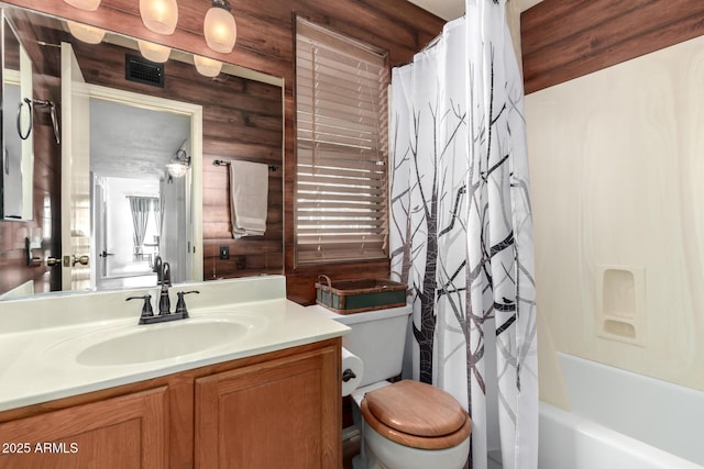 full bathroom featuring vanity, shower / bath combination with curtain, toilet, and wooden walls