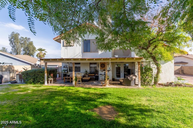 back of property featuring french doors, a yard, and a patio area