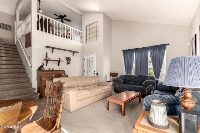 living room with carpet, ceiling fan, and high vaulted ceiling