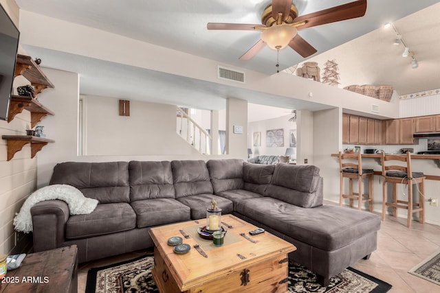 tiled living room with ceiling fan