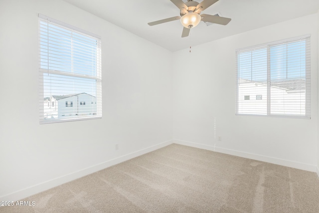 unfurnished room featuring light carpet, baseboards, healthy amount of natural light, and a ceiling fan