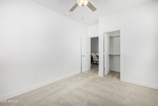 unfurnished bedroom featuring carpet, baseboards, a ceiling fan, and a closet