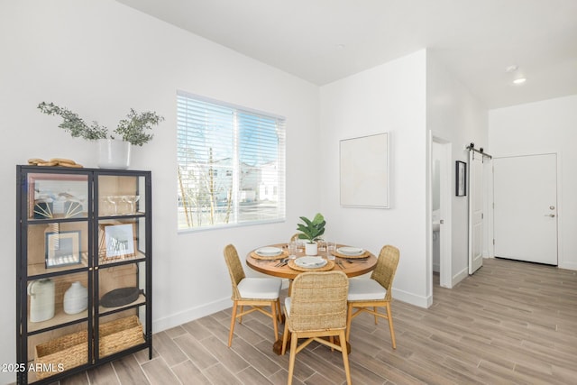 dining room with light wood-style floors, baseboards, and recessed lighting