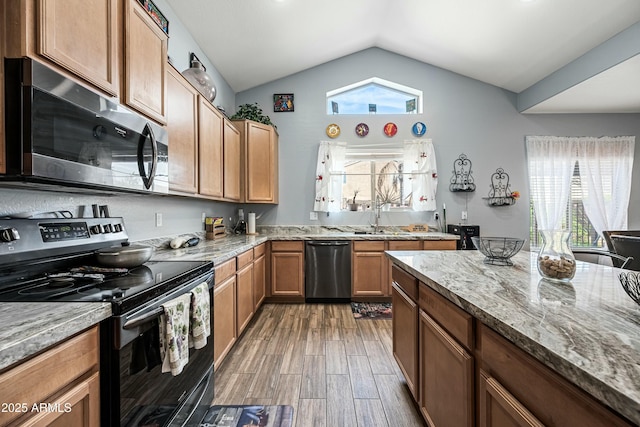 kitchen with lofted ceiling, dishwasher, light stone countertops, black range with electric stovetop, and sink