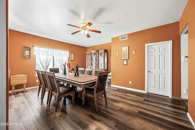 dining room with ceiling fan, a textured ceiling, and dark hardwood / wood-style flooring