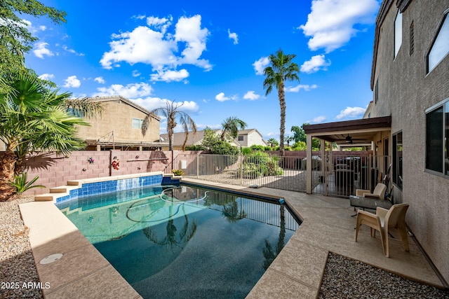 view of swimming pool with ceiling fan and a patio area