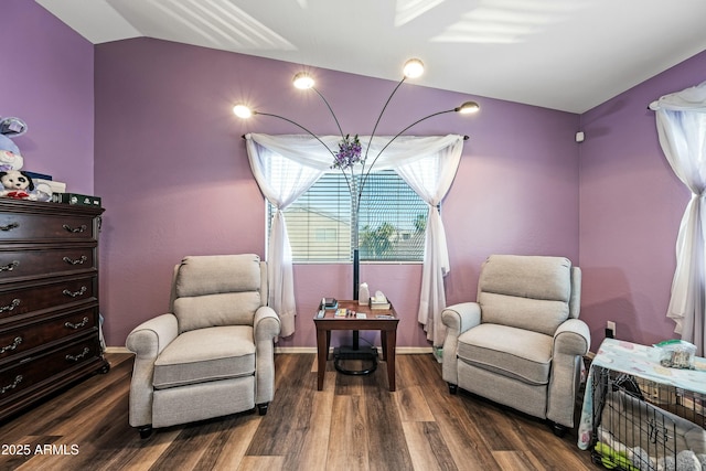 sitting room featuring dark hardwood / wood-style floors and vaulted ceiling