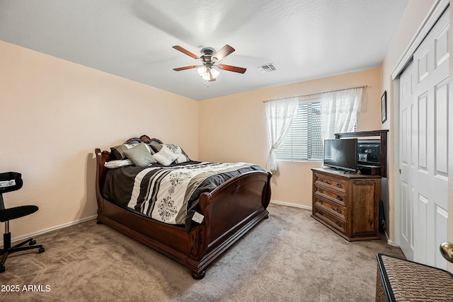 carpeted bedroom featuring ceiling fan and a closet