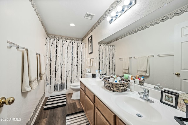 full bathroom featuring toilet, vanity, shower / bath combo with shower curtain, and hardwood / wood-style floors