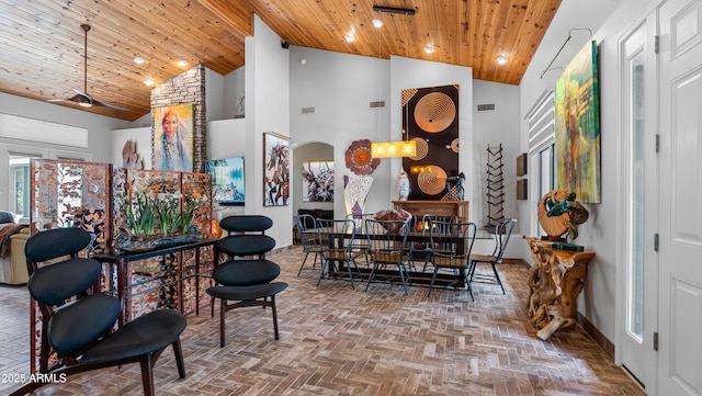 dining space with visible vents, wooden ceiling, baseboards, and high vaulted ceiling