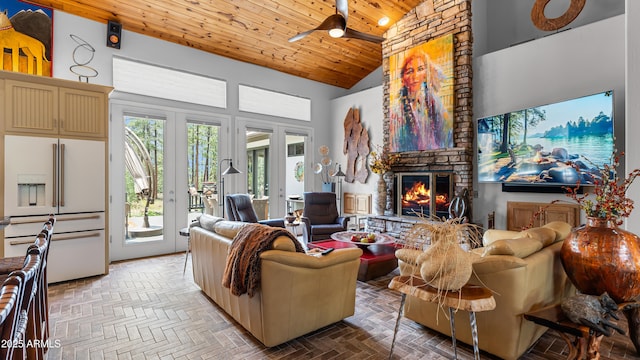 living area featuring wooden ceiling, a stone fireplace, and high vaulted ceiling