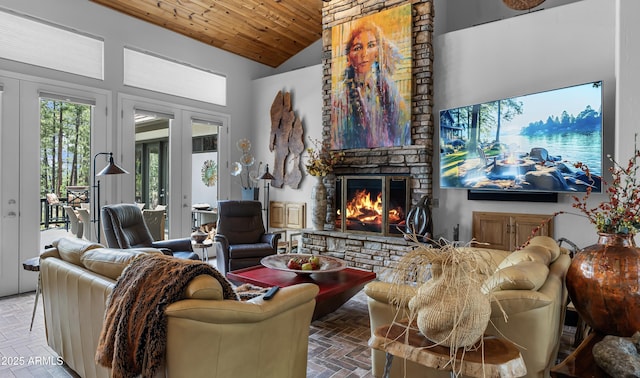 living room featuring french doors, brick floor, wood ceiling, a fireplace, and high vaulted ceiling