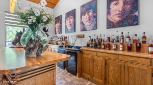 bar with lofted ceiling and a dry bar