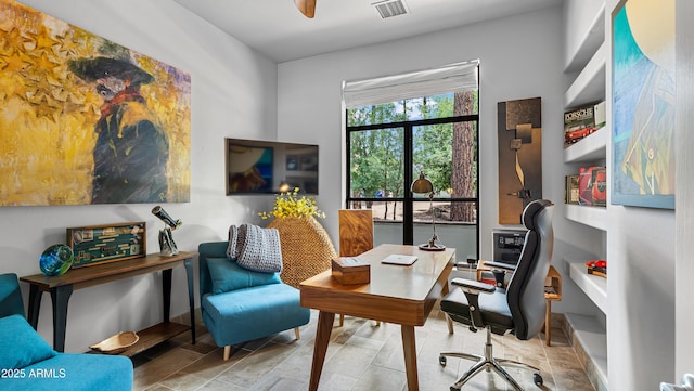 office area with visible vents and a ceiling fan