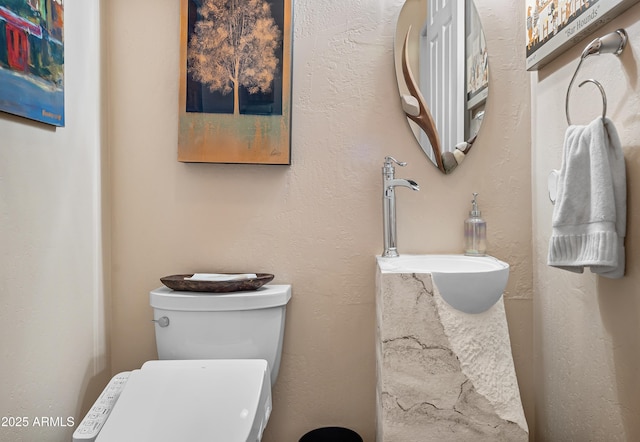 bathroom featuring toilet and a sink