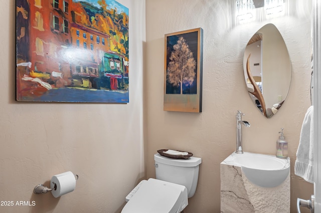 half bath with toilet and a sink