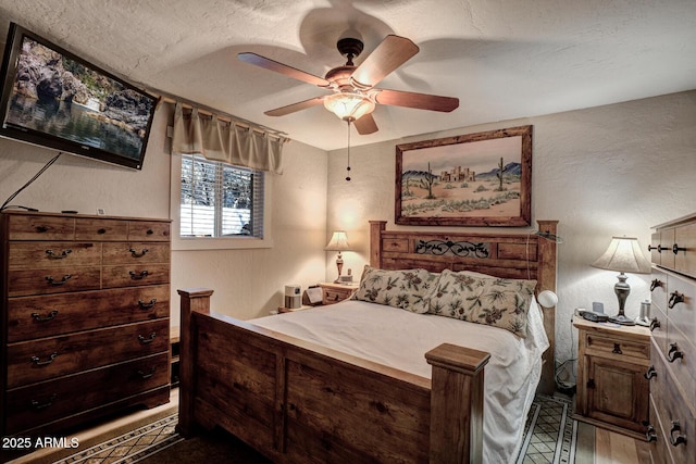 bedroom featuring a textured ceiling and ceiling fan