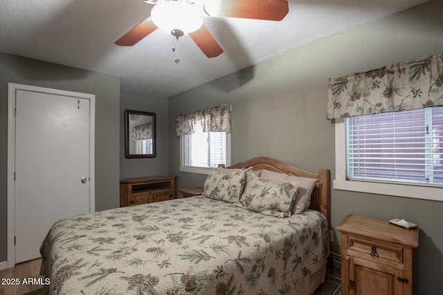 bedroom with ceiling fan and hardwood / wood-style flooring