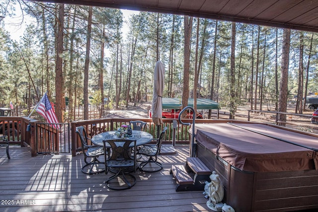 wooden deck with a hot tub