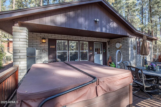 exterior space with a hot tub