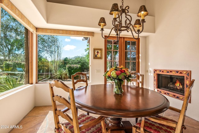 dining area with a notable chandelier and light tile flooring