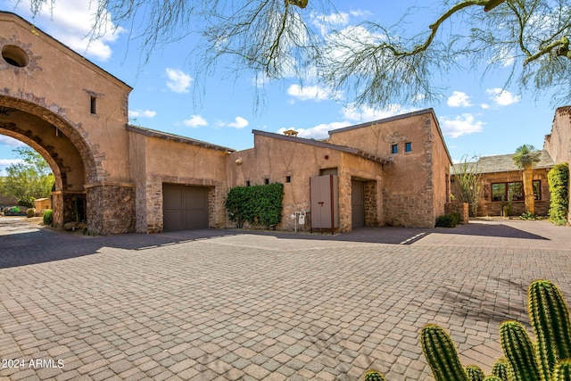 southwest-style home with a garage