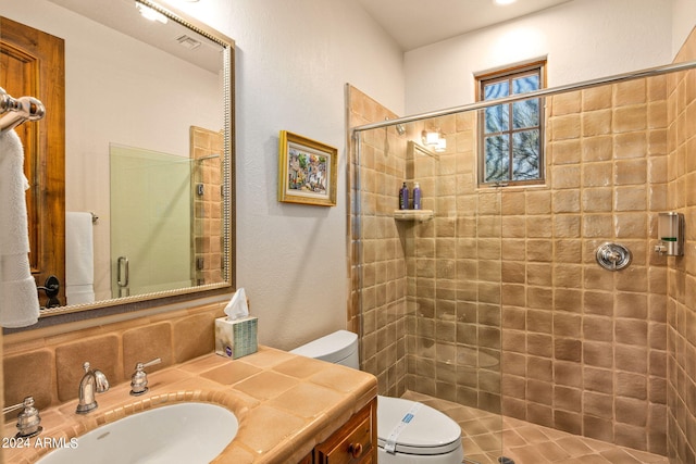 bathroom featuring a shower with door, vanity, and toilet