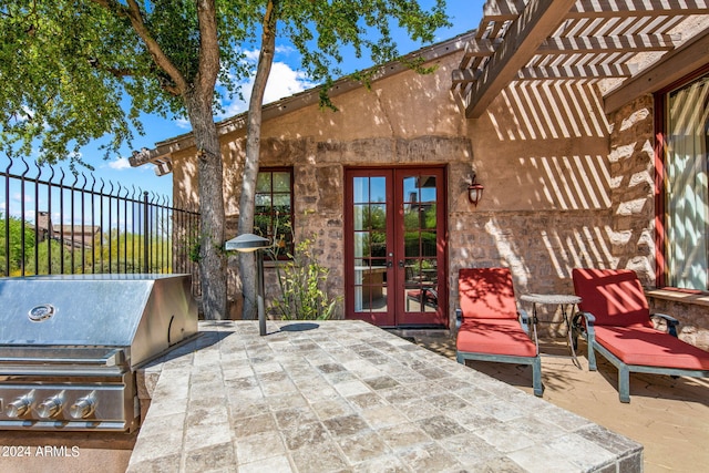 view of terrace featuring french doors, area for grilling, and a pergola