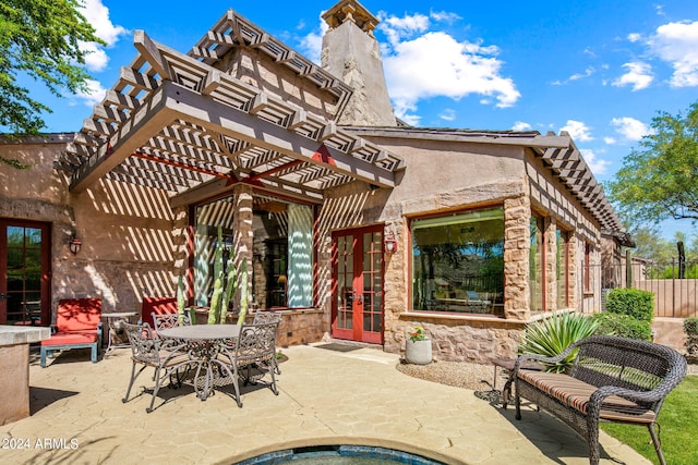 view of patio / terrace featuring french doors and a pergola