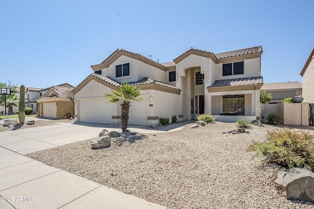 1031 W Longhorn Dr, Chandler, AZ 85286 - mediterranean / spanish-style home with stucco siding, a tiled roof, driveway, and a garage