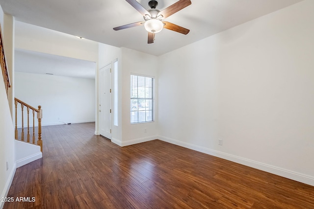 1031 W Longhorn Dr, Chandler, AZ 85286 - empty room featuring stairs, ceiling fan, dark wood finished floors, and baseboards