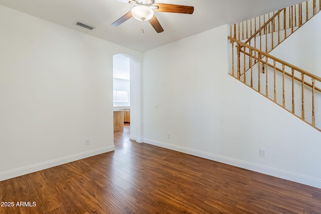 1031 W Longhorn Dr, Chandler, AZ 85286 - empty room with arched walkways, a ceiling fan, wood finished floors, and baseboards
