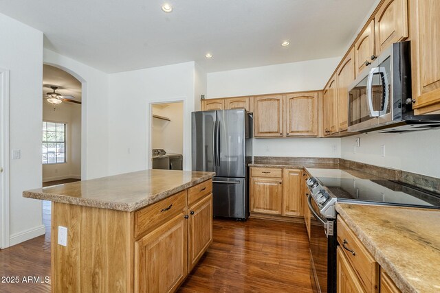 1031 W Longhorn Dr, Chandler, AZ 85286 - kitchen featuring stainless steel appliances, separate washer and dryer, dark wood-style floors, a kitchen island, and recessed lighting