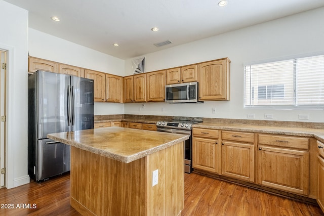 1031 W Longhorn Dr, Chandler, AZ 85286 - kitchen featuring appliances with stainless steel finishes, dark wood finished floors, recessed lighting, and a kitchen island