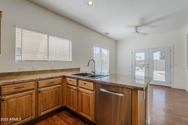 1031 W Longhorn Dr, Chandler, AZ 85286 - kitchen featuring stainless steel dishwasher, a sink, a peninsula, brown cabinets, and a ceiling fan