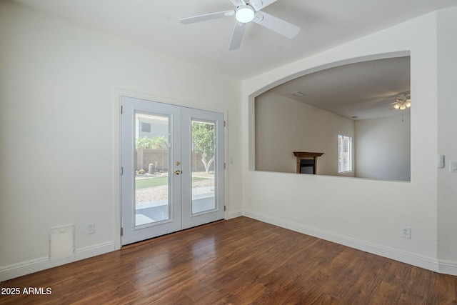 1031 W Longhorn Dr, Chandler, AZ 85286 - unfurnished living room featuring french doors, ceiling fan, wood finished floors, arched walkways, and baseboards
