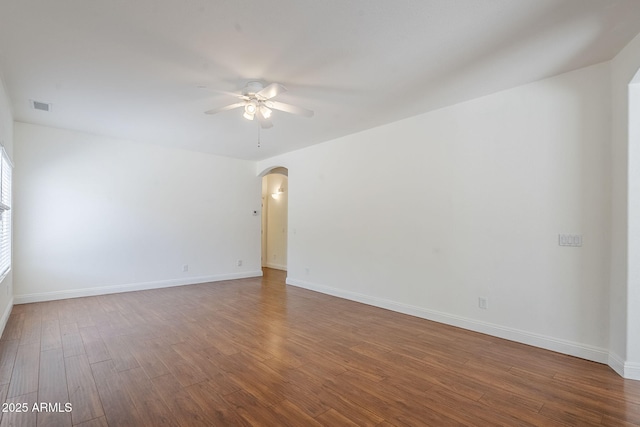 1031 W Longhorn Dr, Chandler, AZ 85286 - empty room with arched walkways, a ceiling fan, wood finished floors, and baseboards