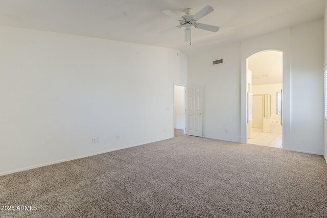 1031 W Longhorn Dr, Chandler, AZ 85286 - unfurnished bedroom featuring arched walkways, carpet floors, baseboards, high vaulted ceiling, and ensuite bathroom