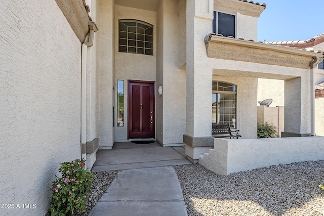 1031 W Longhorn Dr, Chandler, AZ 85286 - view of exterior entry with stucco siding, covered porch, and a tiled roof