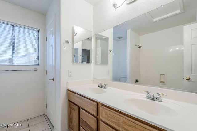 1031 W Longhorn Dr, Chandler, AZ 85286 - bathroom featuring tile patterned floors, double vanity, toilet, a shower, and baseboards