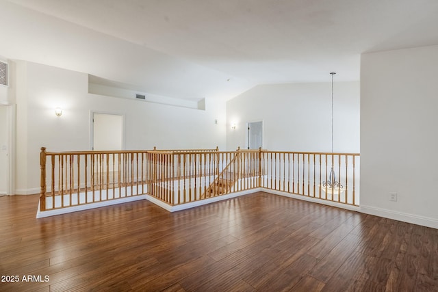 1031 W Longhorn Dr, Chandler, AZ 85286 - empty room featuring wood finished floors, vaulted ceiling, and baseboards