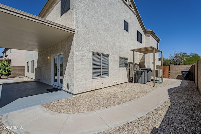 1031 W Longhorn Dr, Chandler, AZ 85286 - back of property featuring a patio, stucco siding, and french doors