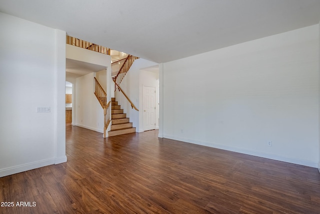 1031 W Longhorn Dr, Chandler, AZ 85286 - spare room featuring stairway, dark wood-style flooring, and baseboards