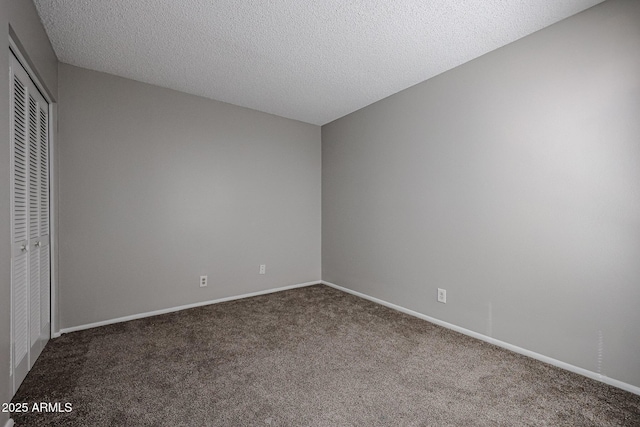 unfurnished bedroom with a closet, a textured ceiling, and carpet